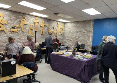 A group of people eating snacks and conversing at the Grape Expectations Benefits Gala.