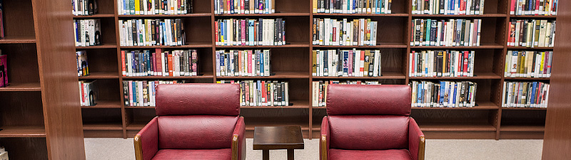 Two crimson leather chairs with a table in between at Bolivar County Library System Two crimson leather chairs with a table in between at Bolivar County Library System